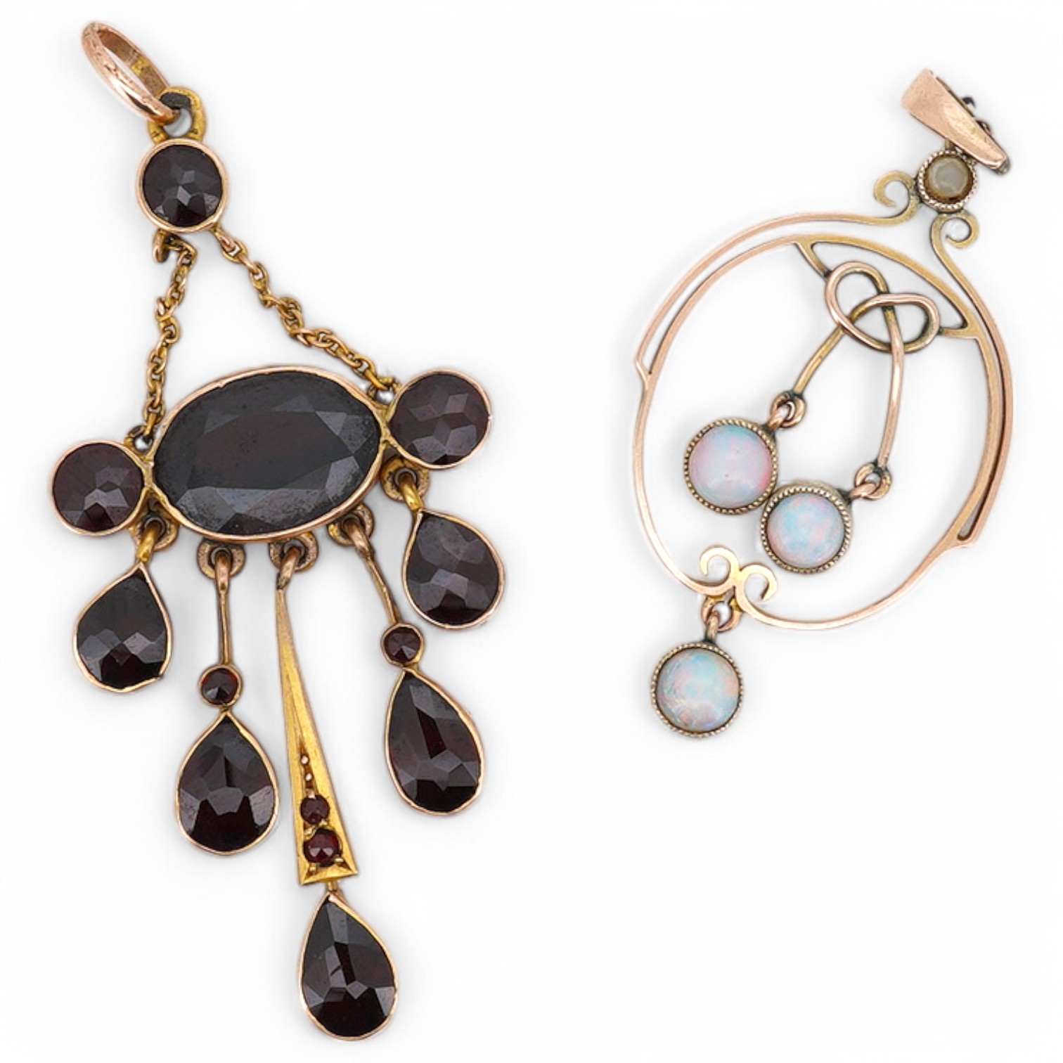 An early 20th century yellow metal and garnet cluster set drop pendant, 46mm, together with a similar opal set drop pendant, stamped '9', 37mm, gross weight 4.5 grams. Condition - fair to good